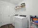 Functional laundry room with a washer, dryer, and storage shelves at 637 Scotch Meadows Loop, Monroe, NC 28110