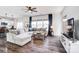 Spacious living room with hardwood floors, large windows, and a comfortable sectional sofa at 637 Scotch Meadows Loop, Monroe, NC 28110