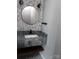 Stylish bathroom featuring a unique hexagonal tile wall, modern fixtures, and granite countertop at 6518 Blackwood Ln, Waxhaw, NC 28173