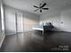 Bright bedroom with a ceiling fan, dark laminate floors, and natural light streaming in from the window at 6518 Blackwood Ln, Waxhaw, NC 28173