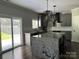 Modern kitchen featuring gray cabinets, stainless steel appliances, and a spacious island with granite countertops at 6518 Blackwood Ln, Waxhaw, NC 28173