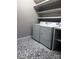 Functional laundry room with washer and dryer, white shelves, and patterned tile flooring for added style at 6518 Blackwood Ln, Waxhaw, NC 28173