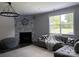 Comfortable living room with a modern fireplace, stylish furnishings, and plenty of natural light from a large window at 6518 Blackwood Ln, Waxhaw, NC 28173