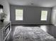 Inviting living room with neutral colors, a decorative fireplace, and bright windows providing ample natural light at 6518 Blackwood Ln, Waxhaw, NC 28173