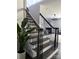 Elegant staircase with dark wood treads, wrought iron spindles, and views into the open living space at 6518 Blackwood Ln, Waxhaw, NC 28173