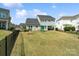 Large, fenced backyard with a green lawn, play set, and a patio area at 660 Daventry Ct # 35, Clover, SC 29710