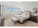 Bright bedroom features a large bed, tray ceilings, bench and plenty of natural light at 660 Daventry Ct # 35, Clover, SC 29710