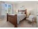 Cozy bedroom featuring a wooden bed frame, soft lighting, and a large window with view of the outdoors at 660 Daventry Ct # 35, Clover, SC 29710