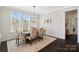 Inviting dining room with a wooden table, six chairs, and large windows that flood the space with natural light at 660 Daventry Ct # 35, Clover, SC 29710