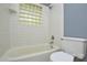 Bathroom with tiled walls, bathtub, and toilet at 7224 Kuck Rd, Mint Hill, NC 28227
