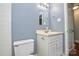 Bathroom with blue walls, mirror, and vanity at 7224 Kuck Rd, Mint Hill, NC 28227