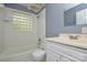 Bathroom with tiled walls, glass block window, and vanity at 7224 Kuck Rd, Mint Hill, NC 28227