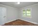 Bedroom with hardwood floors, a window, and a door at 7224 Kuck Rd, Mint Hill, NC 28227