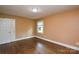 Bedroom with hardwood floors, window and white door at 7224 Kuck Rd, Mint Hill, NC 28227