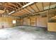 Spacious garage with wooden walls and high ceilings, ready for customization and ample storage solutions at 7224 Kuck Rd, Mint Hill, NC 28227