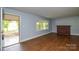 Open living room with hardwood floors, fireplace, and ample natural light at 7224 Kuck Rd, Mint Hill, NC 28227