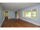 The spacious living room has hardwood floors and a great view of the mature landscaping at 7224 Kuck Rd, Mint Hill, NC 28227