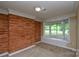 Living room with a brick accent wall, bay window, and natural light at 7224 Kuck Rd, Mint Hill, NC 28227