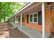Inviting covered porch featuring classic brick and neutral trim at 7224 Kuck Rd, Mint Hill, NC 28227