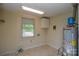 A utility room with a water heater, a window, and overhead lighting at 7224 Kuck Rd, Mint Hill, NC 28227