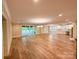 Open concept finished basement with luxury vinyl plank flooring and sliding glass doors at 724 Ideal Way, Charlotte, NC 28203