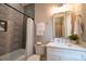 This bathroom features decorative tile, a bathtub, and a large, framed vanity mirror for a bright and relaxing atmosphere at 724 Ideal Way, Charlotte, NC 28203