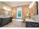 Bathroom with stand alone tub and wood accent wall at 724 Ideal Way, Charlotte, NC 28203