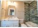 Bathroom with marble countertop vanity, a mirror, and stylish tiled walls in shower at 724 Ideal Way, Charlotte, NC 28203