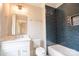This bathroom features a modern vanity, stylish mirror and blue tile accent wall for an updated, sleek look at 724 Ideal Way, Charlotte, NC 28203