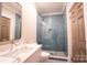 Modern bathroom features a glass-enclosed shower with stylish blue tiles and a white marble vanity at 724 Ideal Way, Charlotte, NC 28203