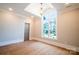 Bright bedroom with hardwood floors, large window, and stylish light fixture at 724 Ideal Way, Charlotte, NC 28203