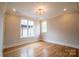 Bright, spacious bedroom with hardwood floors, natural light, and modern lighting fixture at 724 Ideal Way, Charlotte, NC 28203