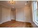 Bedroom featuring hardwood floors, modern trim work, neutral walls and two large closets at 724 Ideal Way, Charlotte, NC 28203
