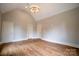 Bedroom featuring modern light fixture, hardwood floors and pitched ceilings at 724 Ideal Way, Charlotte, NC 28203