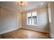 Bedroom features a modern light fixture, hardwood floors, trim work and natural light at 724 Ideal Way, Charlotte, NC 28203