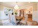 Bright dining room with large windows, chandelier, wainscoting, and seating for eight at 724 Ideal Way, Charlotte, NC 28203