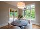 Cozy dining room with a round table, large window, sliding glass door, and modern light fixture at 724 Ideal Way, Charlotte, NC 28203