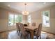 An airy dining room featuring a wood table, seating for six, natural light, and elegant decor at 724 Ideal Way, Charlotte, NC 28203