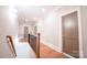 Upstairs hallway with hardwood floors, wood banister, and neutral paint at 724 Ideal Way, Charlotte, NC 28203