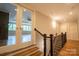 Second floor hallway with stained hardwood floors and a view of the open concept living area at the bottom of stairs at 724 Ideal Way, Charlotte, NC 28203