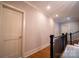 Second floor hallway with stained hardwood floors and white trim and doors, leads to multiple rooms at 724 Ideal Way, Charlotte, NC 28203