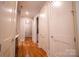Inviting hallway featuring hardwood floors and crisp white trim and doors with brushed nickel hardware at 724 Ideal Way, Charlotte, NC 28203