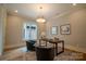 Modern home office features stylish light fixture, neutral paint, and a large window to let the sunshine in at 724 Ideal Way, Charlotte, NC 28203