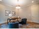 Bright home office space features neutral paint, stylish light fixture, and modern décor, with hardwood floors at 724 Ideal Way, Charlotte, NC 28203