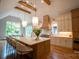 Open kitchen with a large island, stainless steel appliances, wood beam ceiling, and plenty of natural light at 724 Ideal Way, Charlotte, NC 28203