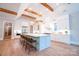 Bright kitchen with an island and seating and high ceilings with wooden beams at 724 Ideal Way, Charlotte, NC 28203