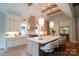 Beautiful kitchen with island, white cabinets, stainless steel appliances, hardwood floors, and wood beam ceiling at 724 Ideal Way, Charlotte, NC 28203