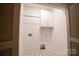 Practical laundry room features tile floor and overhead cabinet, ready for appliances at 724 Ideal Way, Charlotte, NC 28203