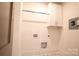 Clean laundry room with cabinets and neutral patterned tile floor at 724 Ideal Way, Charlotte, NC 28203