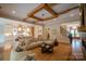 Spacious living room with wood beam ceiling, hardwood floors, open to kitchen, and access to staircase at 724 Ideal Way, Charlotte, NC 28203